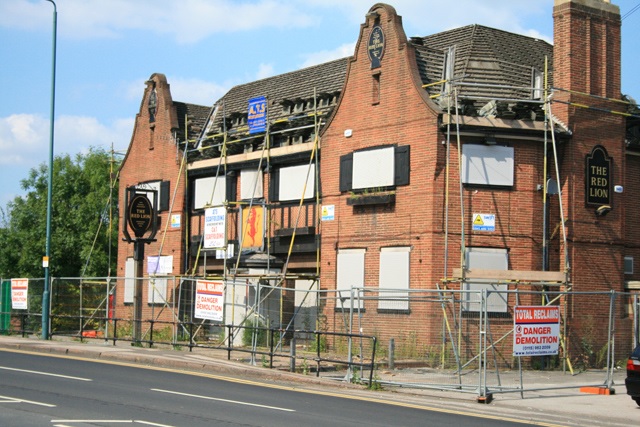 An English pub being demolished in online news & the economy