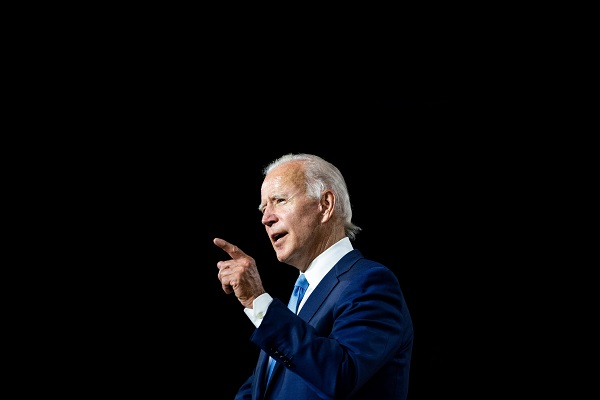 Presdient Biden giving a speech in commentary & editorials