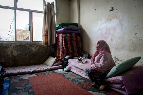 A displaced woman in Syria in headlines & online news